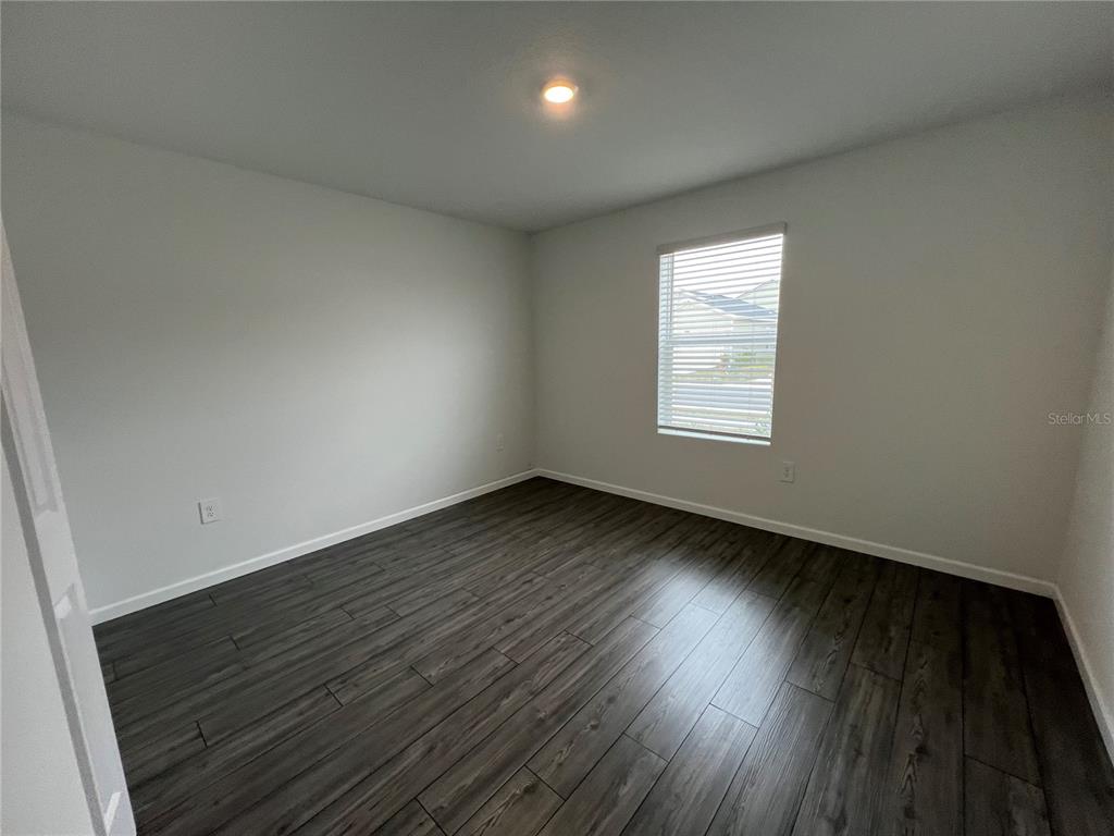 4576 Southwest 84th St Road Ocala, FL 34476 - Photo 17 of 50 an empty room with wooden floor and windows
