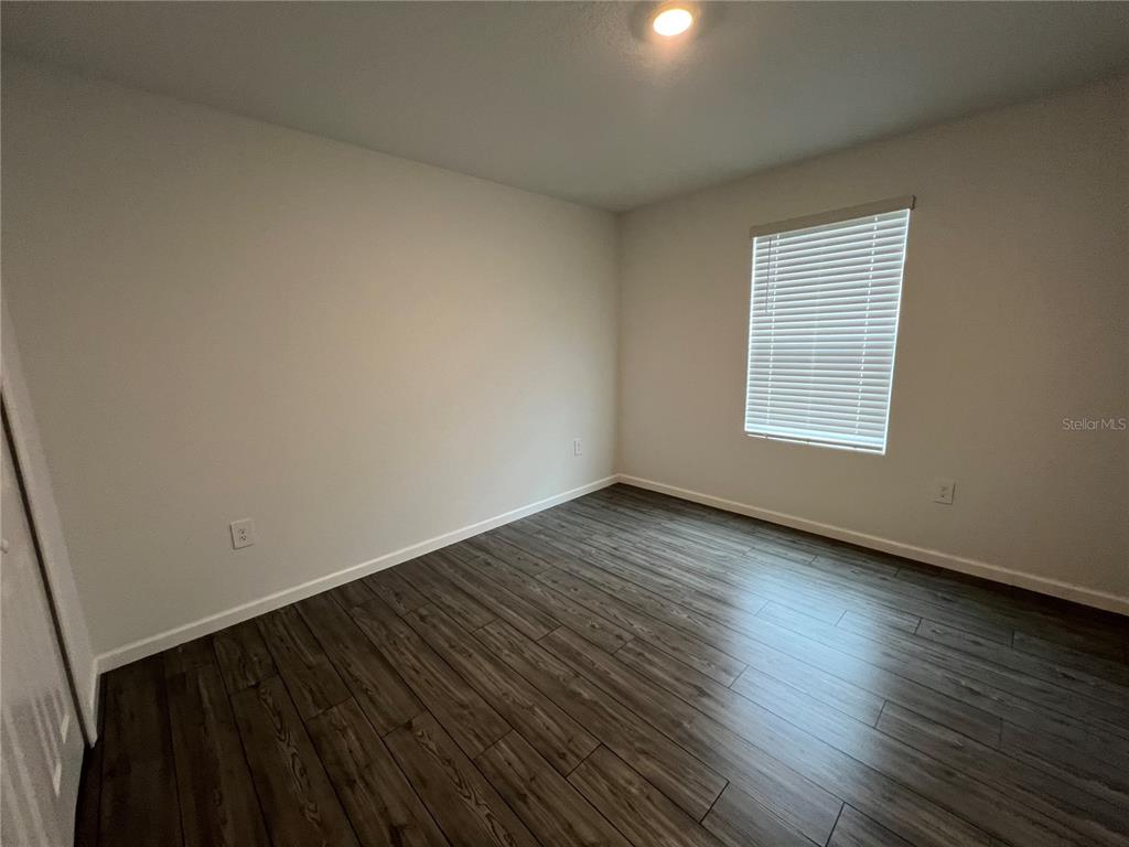 4576 Southwest 84th St Road Ocala, FL 34476 - Photo 21 of 50 an empty room with wooden floor and windows