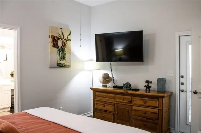 a bedroom with a bed and a flat screen tv