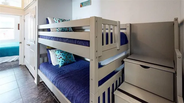 a bedroom with two beds and painting on the wall