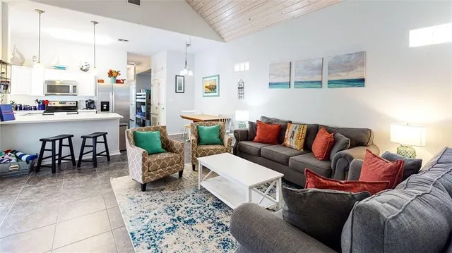 a living room with furniture and a kitchen view