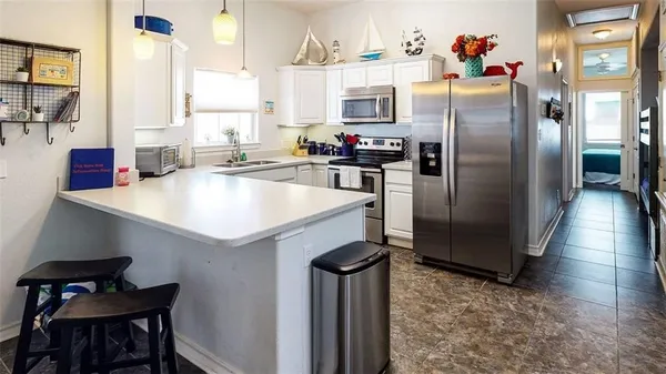 a kitchen with refrigerator and window