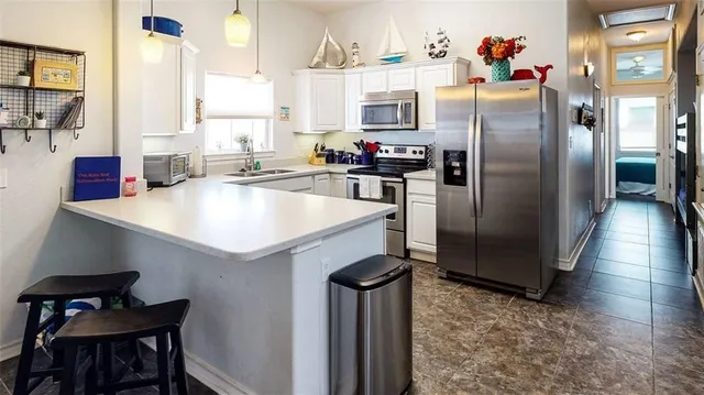 a kitchen with refrigerator and window