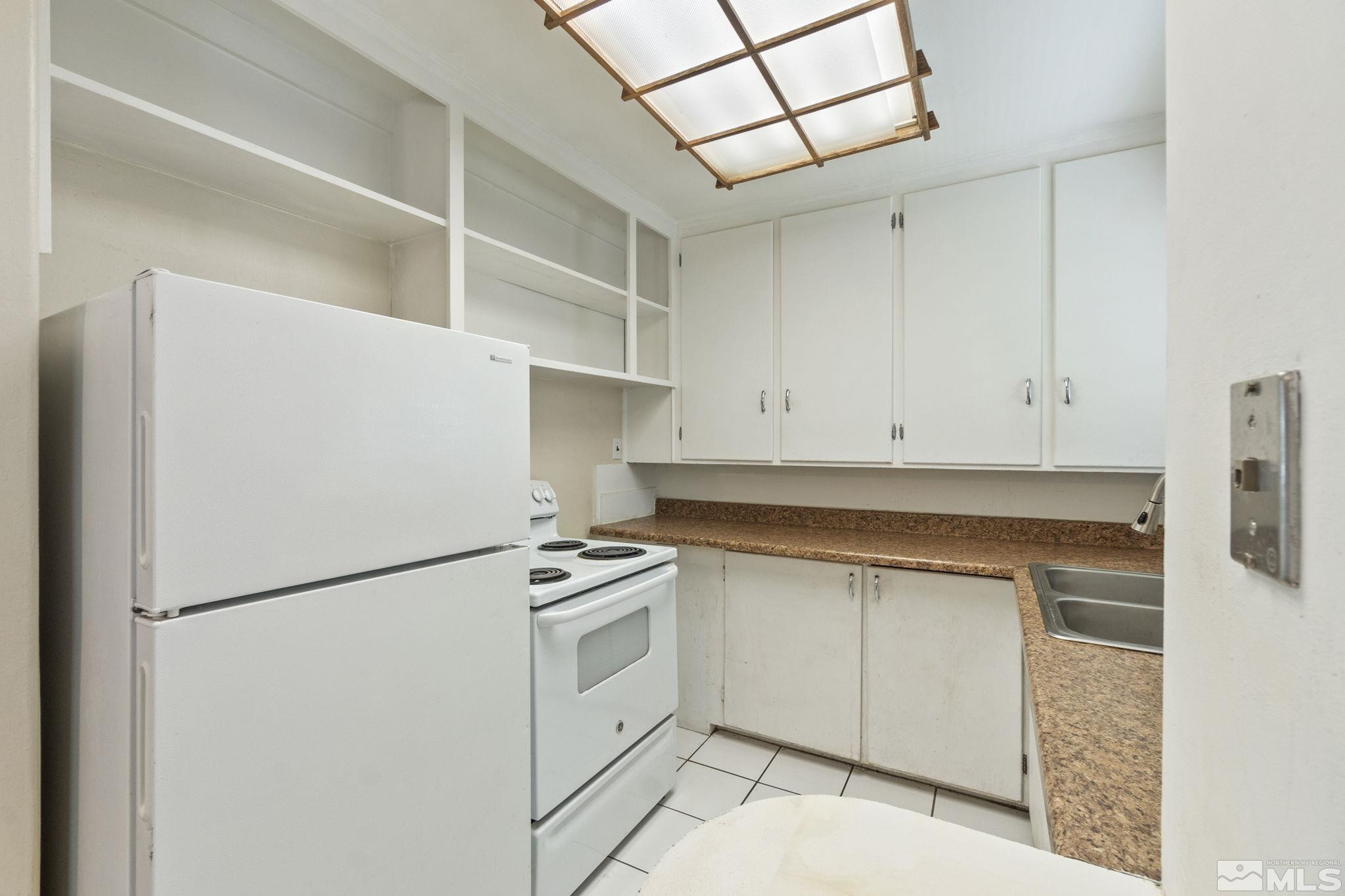 1585 University Terrace Reno, NV 89503 - Photo 15 of 32 a kitchen with stainless steel appliances a refrigerator and a stove top oven