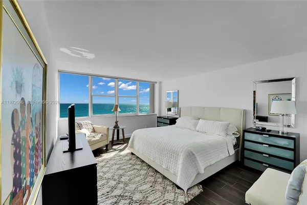 a bedroom with a bed and large window