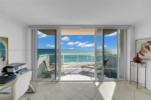 a living room with furniture a floor to ceiling window and a flat screen tv