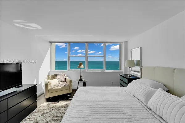 a living room with furniture and a floor to ceiling window