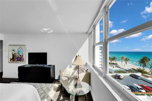 a bathroom with a granite countertop sink a toilet a mirror and shower