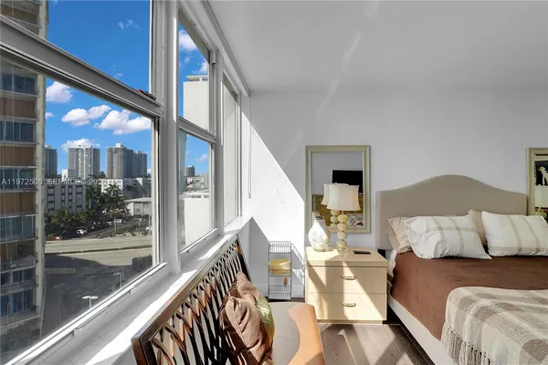 a living room with furniture and a floor to ceiling window