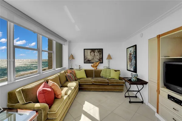 a roof deck with couch and a floor to ceiling window