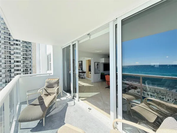 a view of swimming pool with outdoor seating and yard in the back