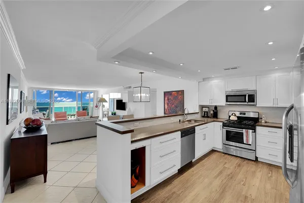 a large kitchen with stainless steel appliances and a stove top oven