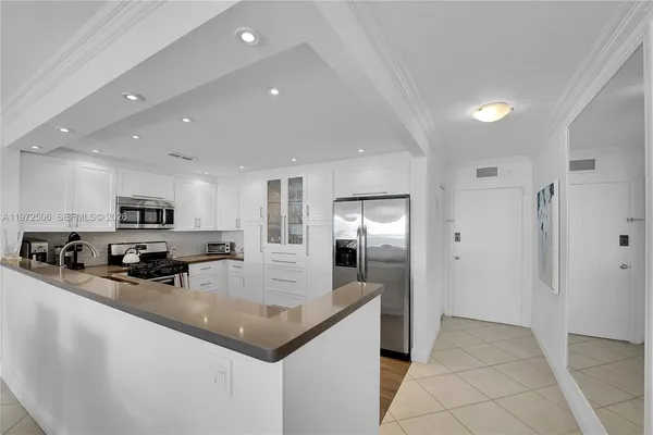 a kitchen with sink refrigerator and microwave