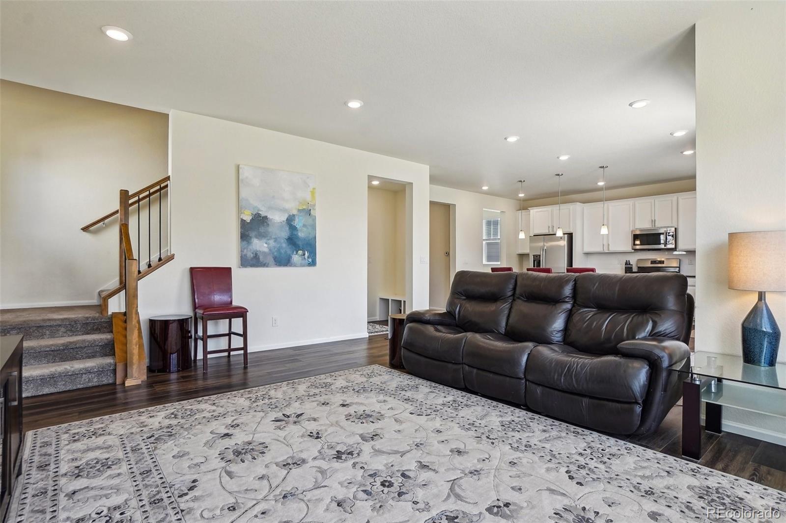 12797 Clearview Street Firestone, CO 80504 - Photo 11 of 44 a living room with furniture and a wooden floor
