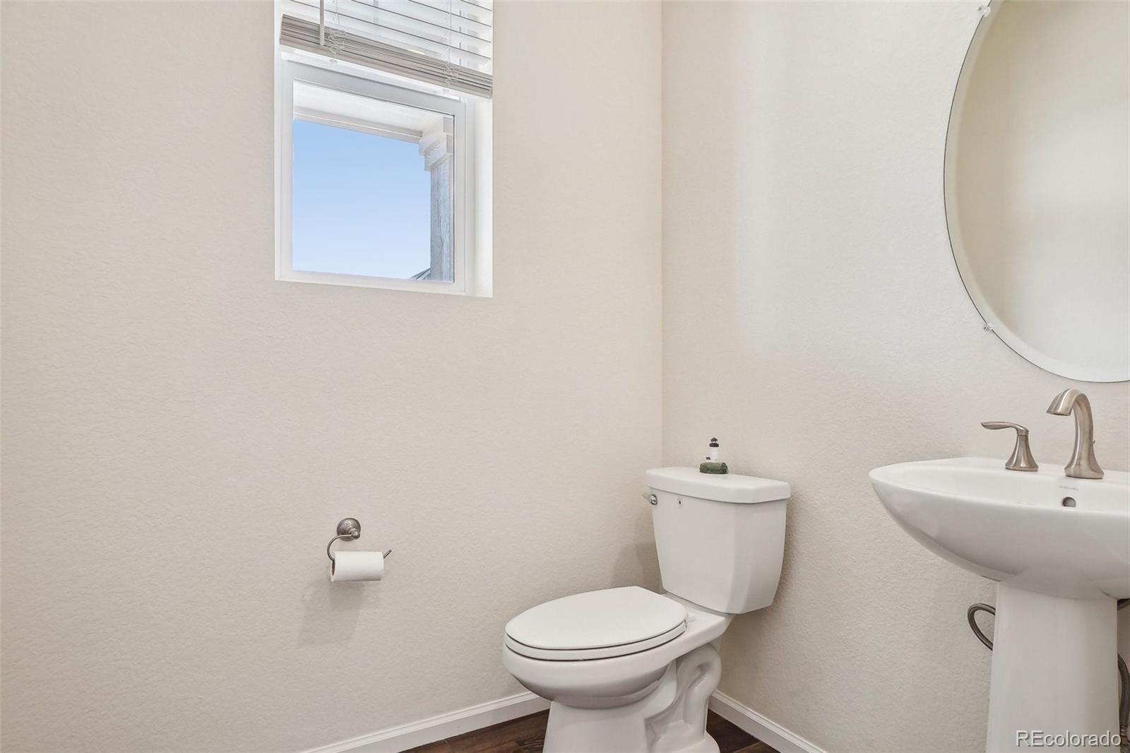 12797 Clearview Street Firestone, CO 80504 - Photo 13 of 44 a bathroom with a sink a toilet and a mirror