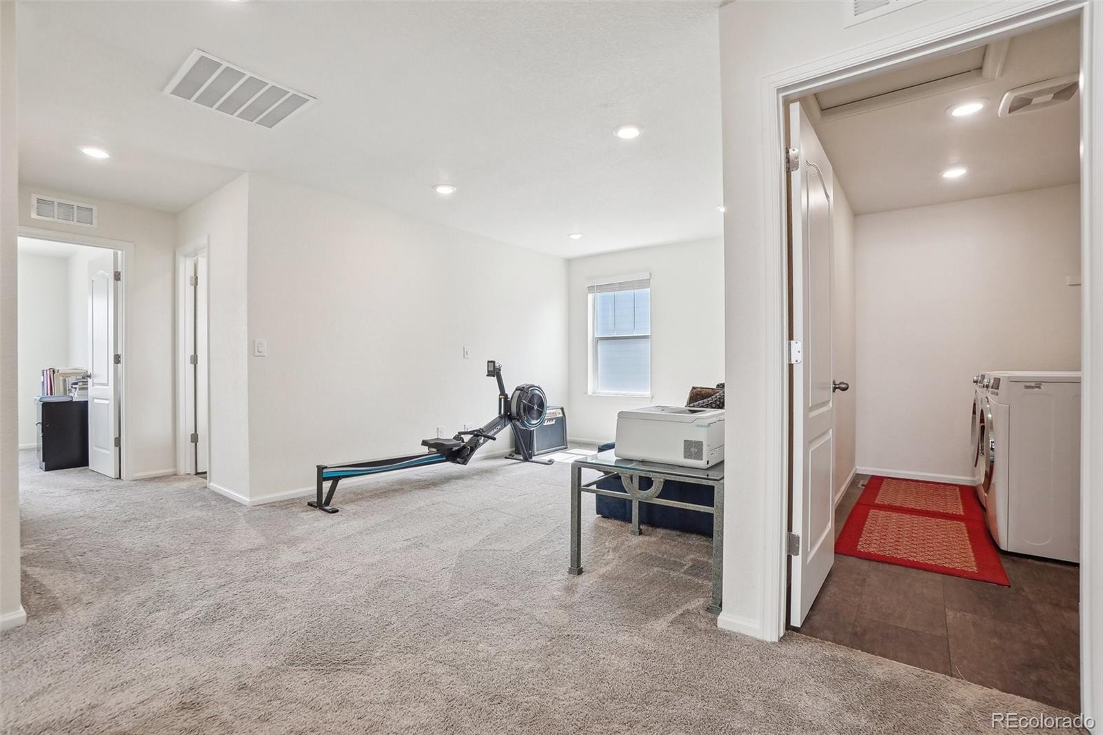 12797 Clearview Street Firestone, CO 80504 - Photo 14 of 44 a view of a livingroom with gym equipment