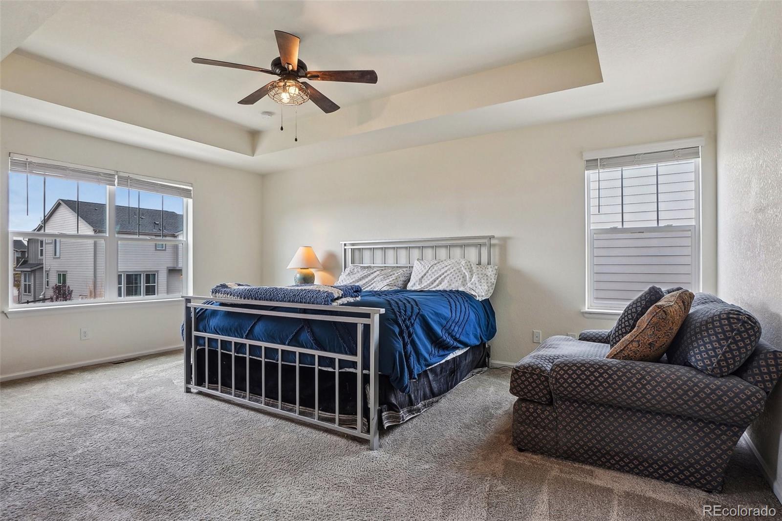 12797 Clearview Street Firestone, CO 80504 - Photo 16 of 44 a bed room with a bed and a couch