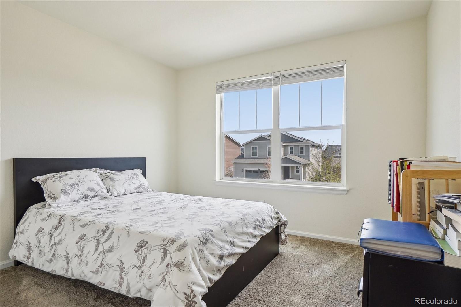12797 Clearview Street Firestone, CO 80504 - Photo 19 of 44 a bedroom with a bed and a window