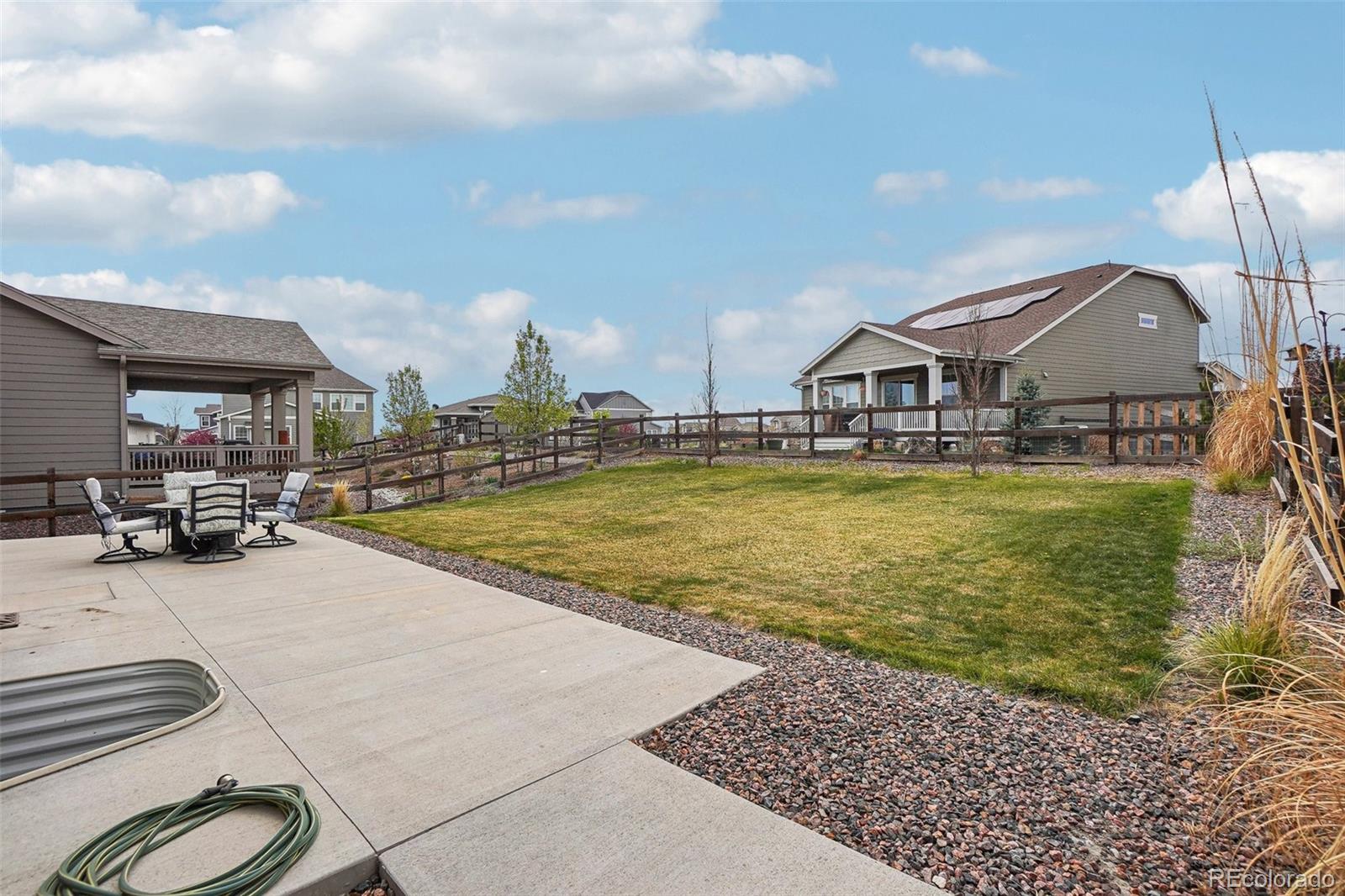 12797 Clearview Street Firestone, CO 80504 - Photo 23 of 44 a view of a swimming pool with a chair and a chandelier