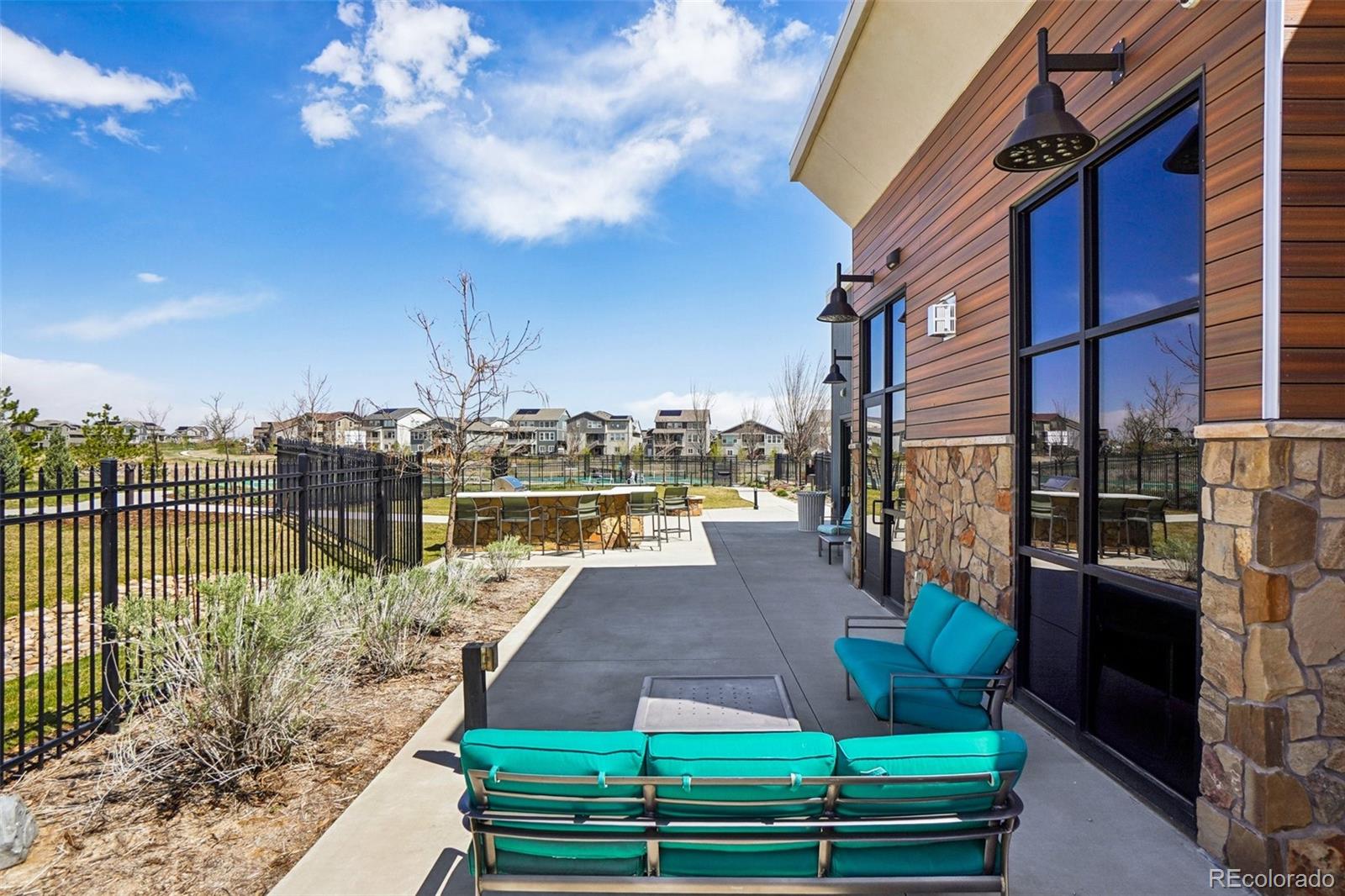 12797 Clearview Street Firestone, CO 80504 - Photo 31 of 44 a view of a patio with couches chairs potted plants and lake view