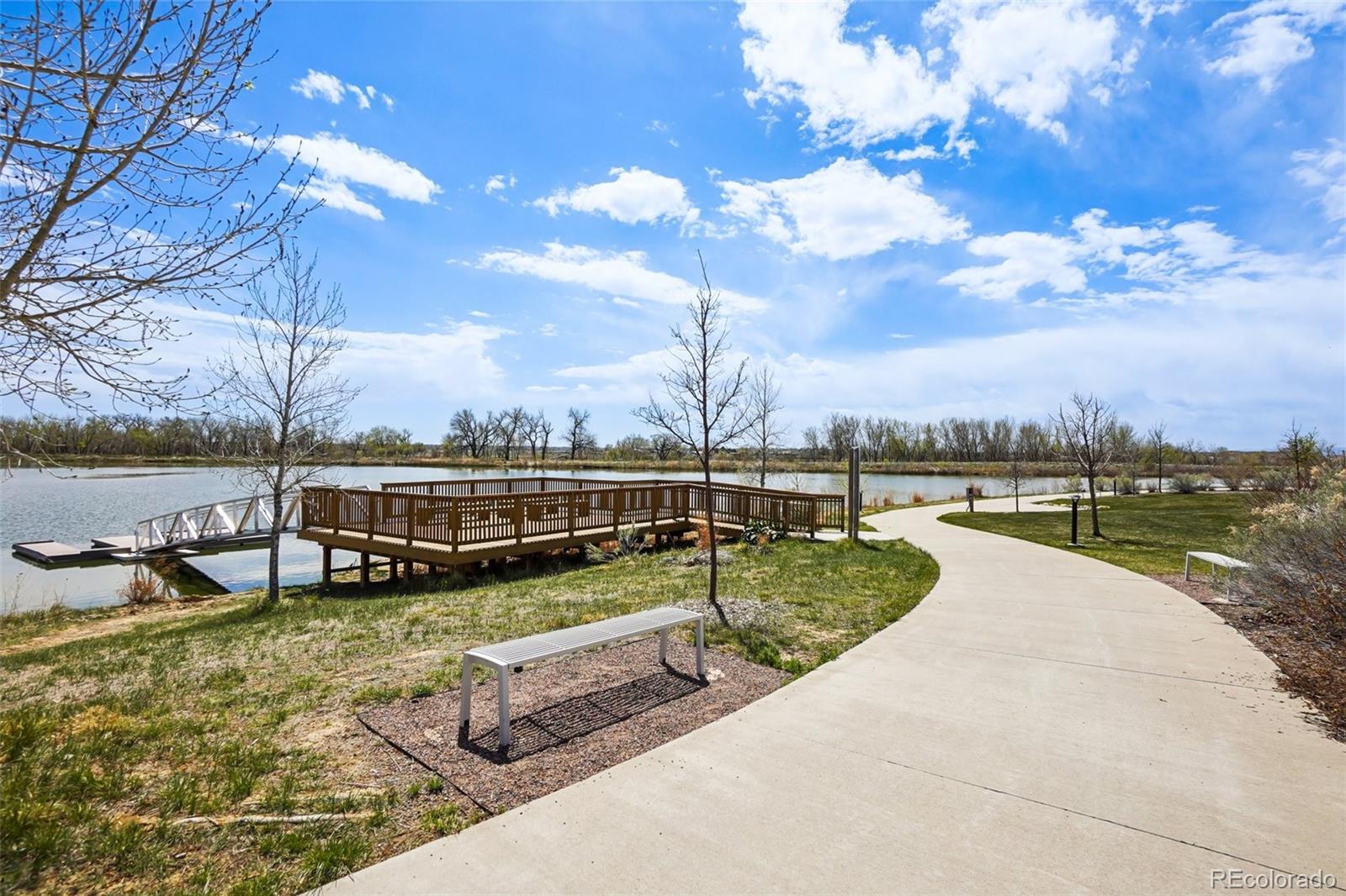12797 Clearview Street Firestone, CO 80504 - Photo 35 of 44 a view of a lake with couches in the patio