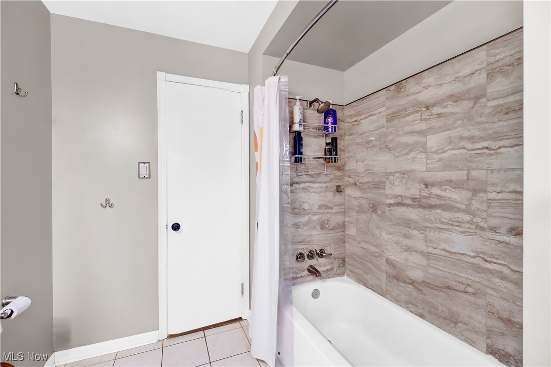 1051 Rockside Road Independence, OH 44131 - Photo 14 of 30 Full bathroom featuring tile patterned flooring, shower / bathtub combination with curtain, and baseboards