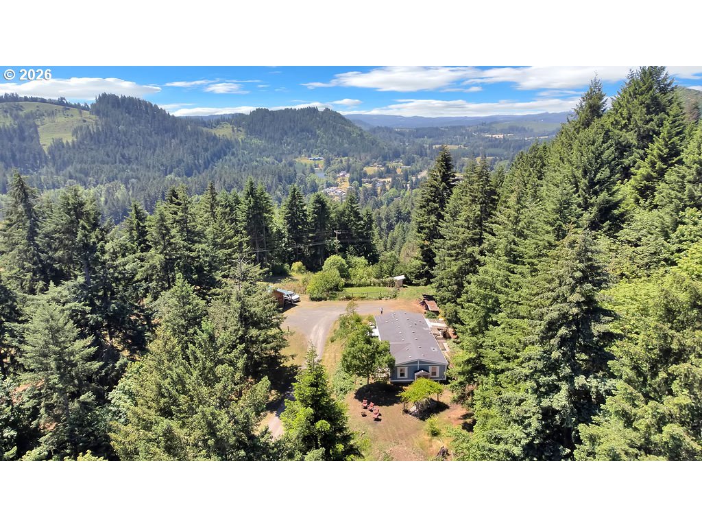 35235 Row River Road Cottage Grove, OR 97424 - Photo 4 of 28 a view of a city with lush green forest