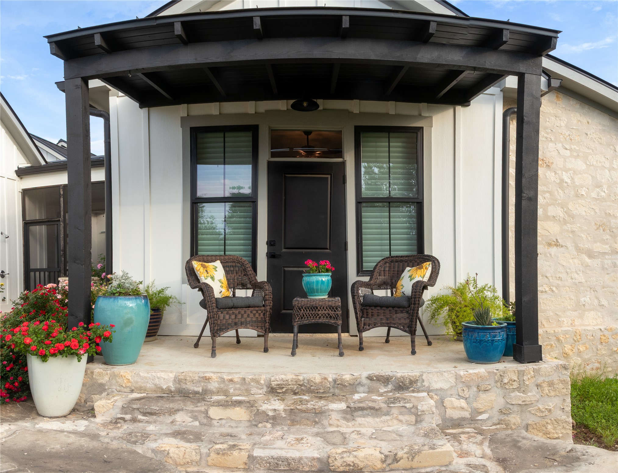 272 Slate Rock Road Fredericksburg, TX 78624 - Photo 2 of 32 A welcoming secondary bedroom porch invites relaxation with comfortable seating.