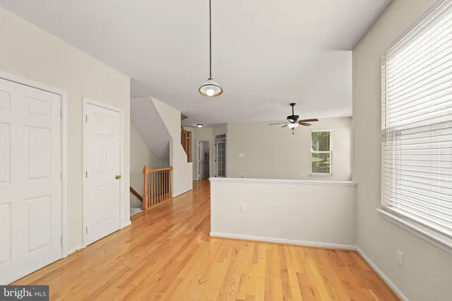 a kitchen with granite countertop wooden floors a sink a counter space and stainless steel appliances