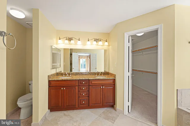 a spacious bathroom with a granite countertop tub sink and mirror