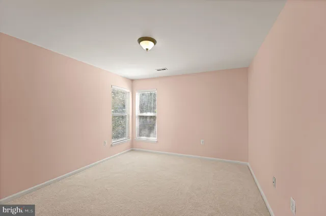 an empty room with a empty space and windows