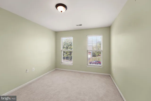 a bathroom with a granite countertop bathtub shower sink vanity and toilet