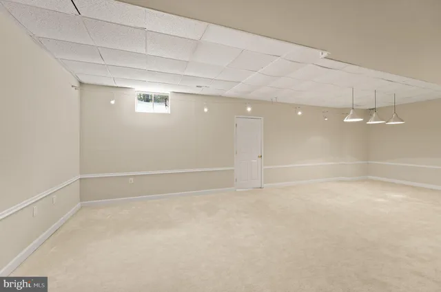 an empty room with a empty space and a ceiling fan
