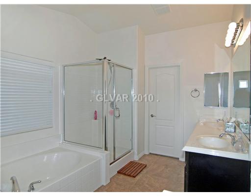 1348 Spice Ridge Court Henderson, NV 89012 - Photo 6 of 8 Master Bath/Spa. Seperate oversized shower and tub in master bath, rich dark cherry vanity with sculpturted top, walk-in closet and balcony.