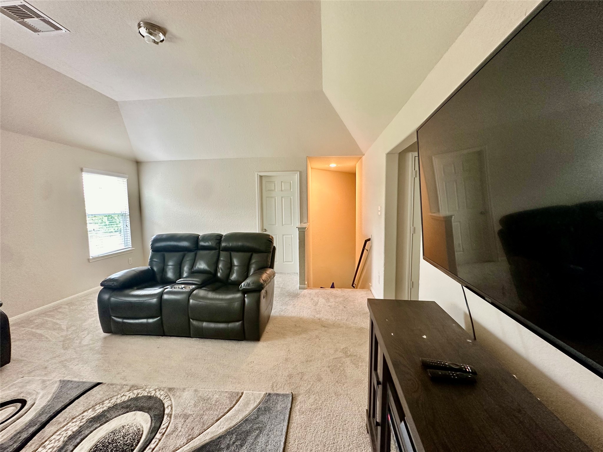 18622 Each Elm Way Houston, TX 77084 - Photo 27 of 35 a living room with furniture and a flat screen tv