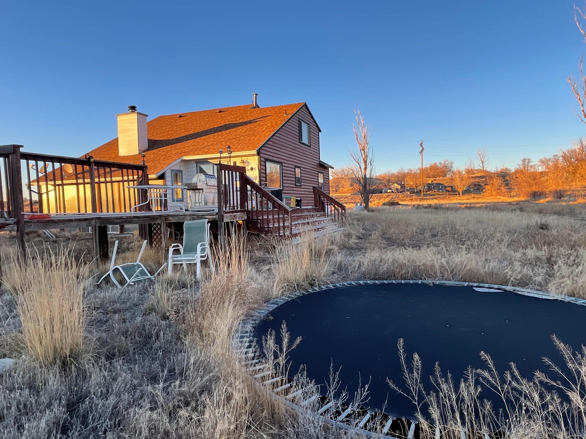 1268-17 17 1/2 Road Fruita, CO 81521 - Photo 14 of 40 a view of a house with a yard next to a lake