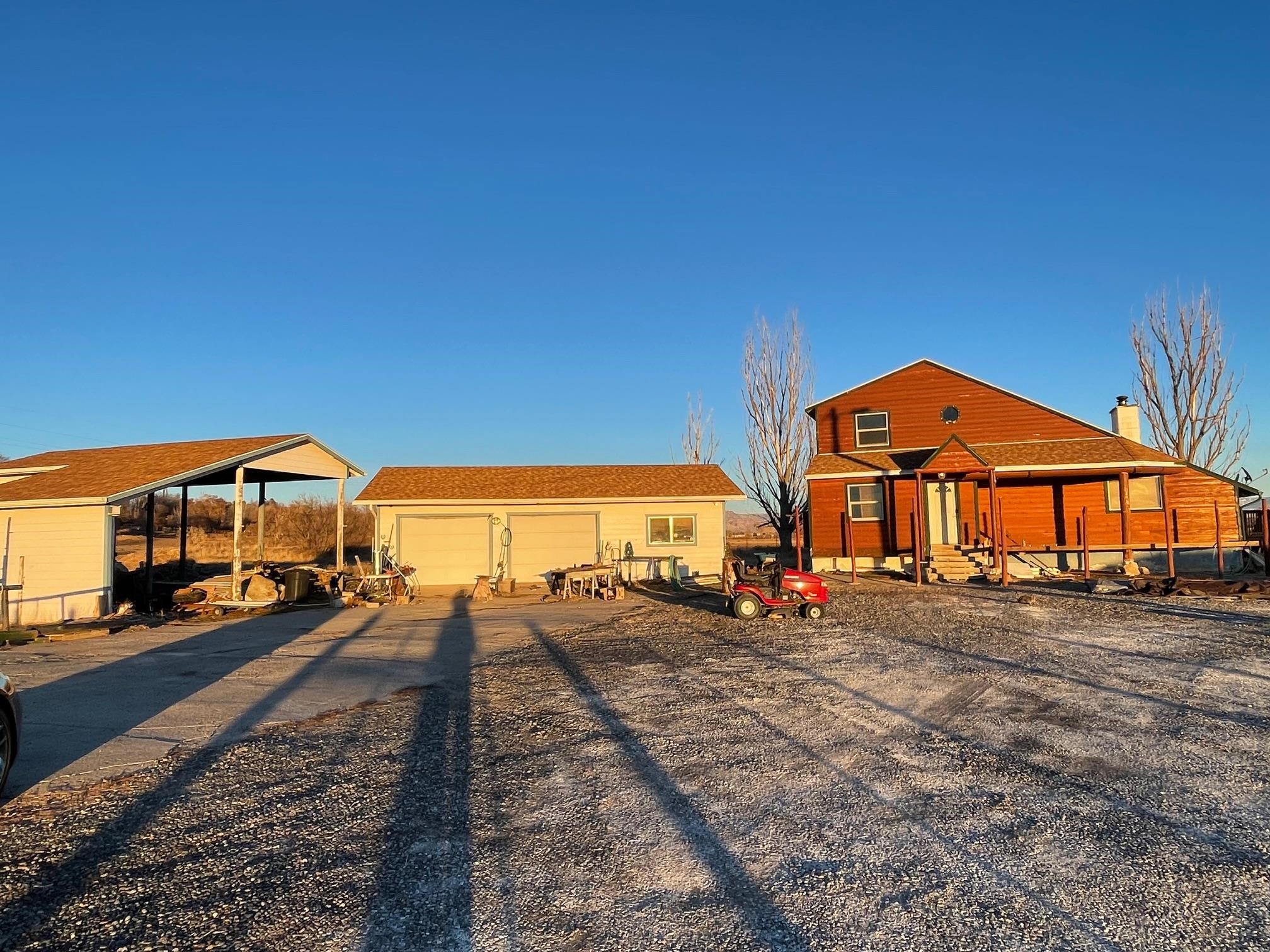 1268-17 17 1/2 Road Fruita, CO 81521 - Photo 5 of 40 a view of a big house with a big yard and large trees