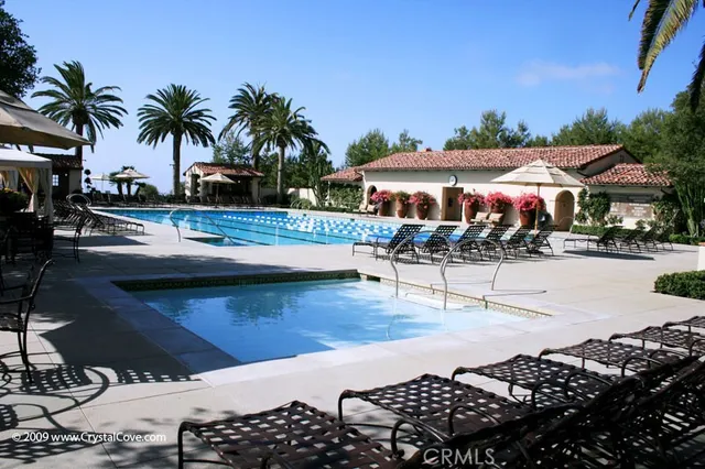 a view of a swimming pool and lounge chairs