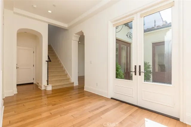 a view of entryway with wooden floor and stairs