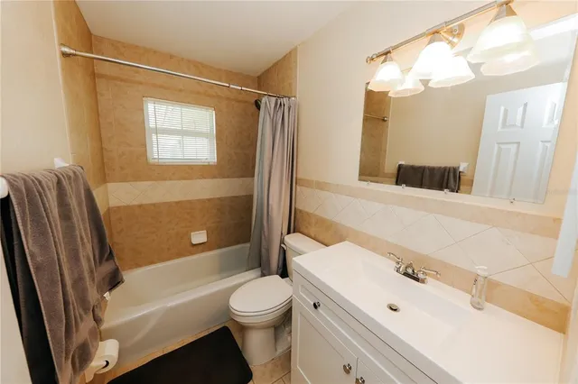 a view of a dining room with furniture and a chandelier