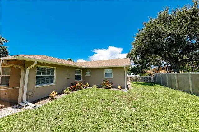 a view of a house with a yard and sitting area