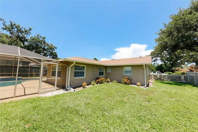 a view of a house with backyard and a garden