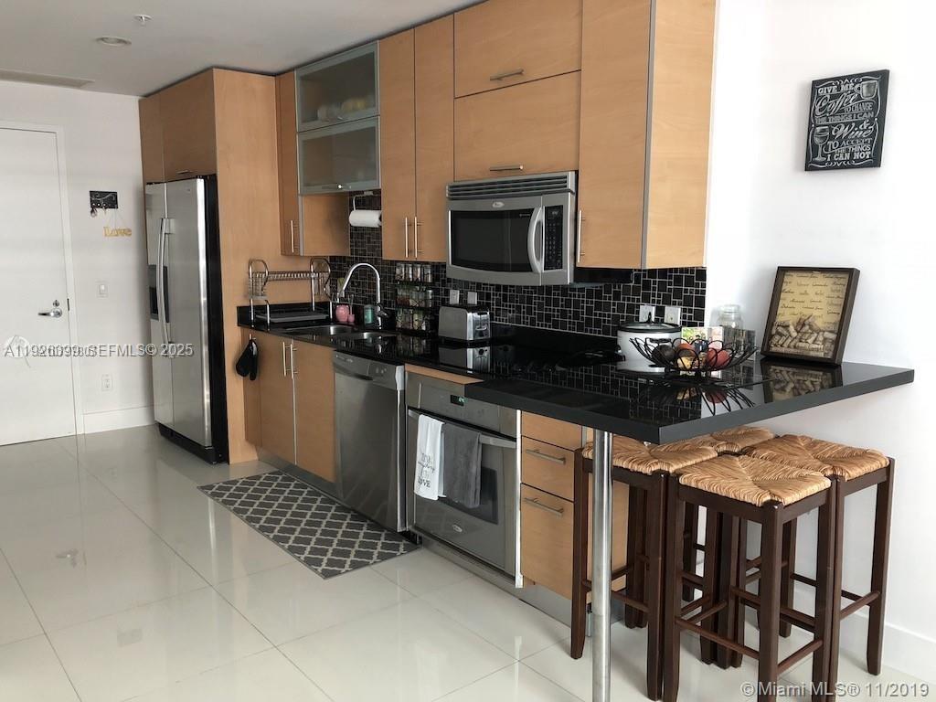 60 Southwest 13th Street, Unit 3218 Miami, FL 33130 - Photo 7 of 11 a kitchen with stainless steel appliances granite countertop a stove refrigerator sink and microwave