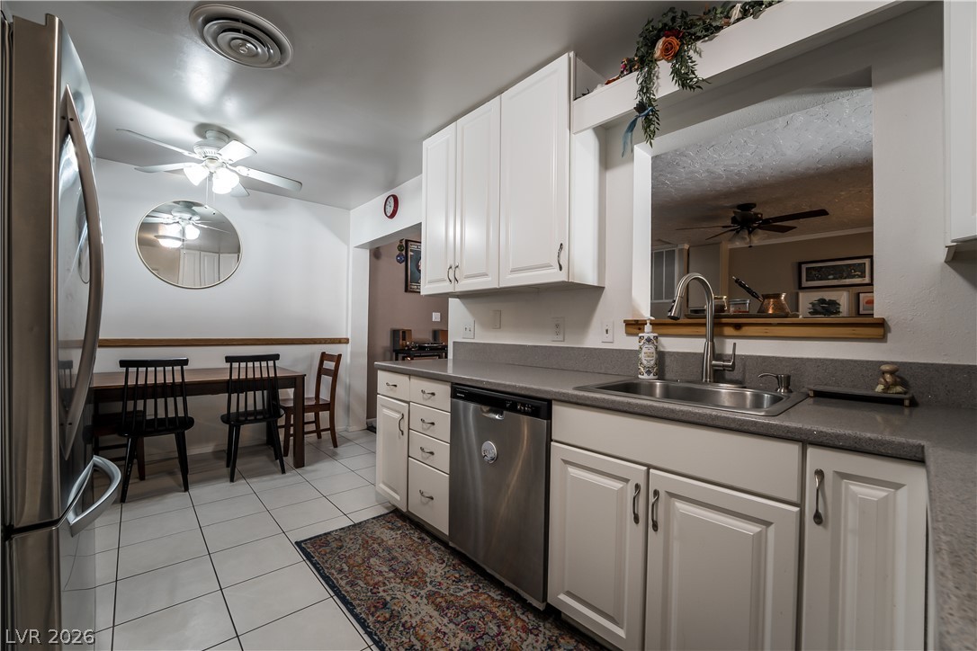 1324 Appaloosa Road Boulder City, NV 89005 - Photo 11 of 42 Functional kitchen with ample cabinet storage and a convenient pass-through window.