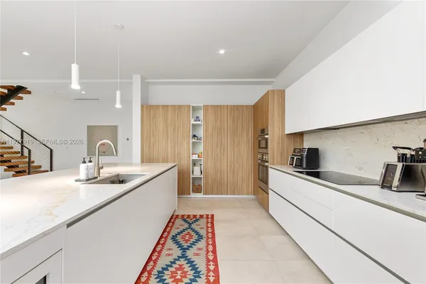 a kitchen with a sink and a refrigerator