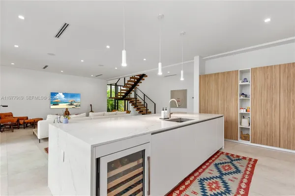 a living room with furniture a rug and a chandelier