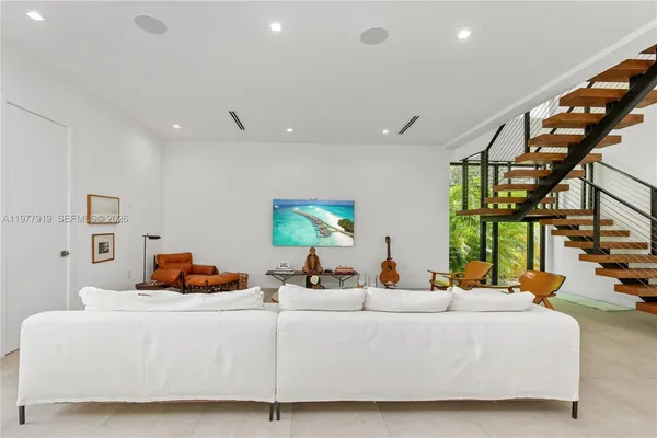 a living room with furniture and a potted plant