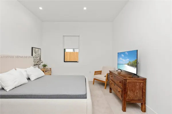 a bedroom with a bed and a couch