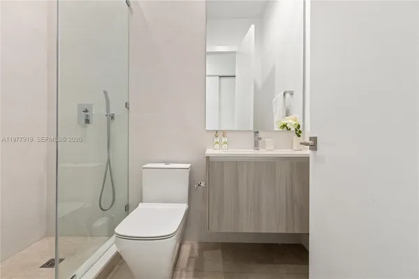 a bathroom with a toilet a sink and shower