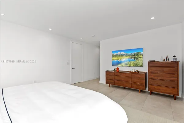 a bathroom with a bathtub sink and mirror